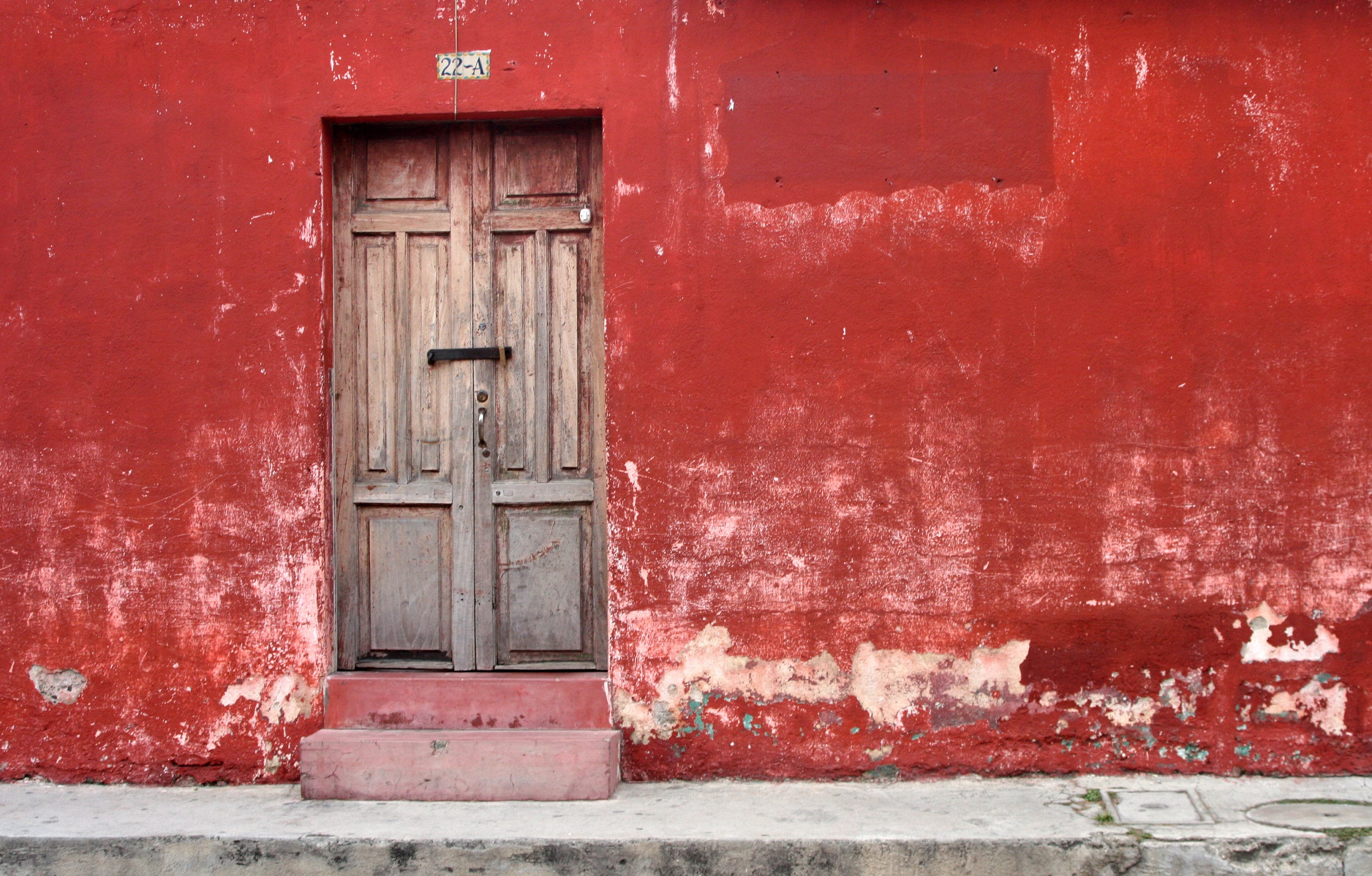 Antigua Guatemala Wall Art: Rustic Red Peeling Paint and Historic Wooden Door Photo